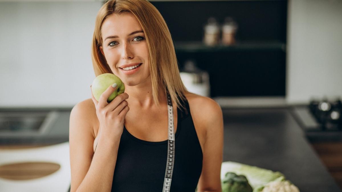 young-woman-with-measuting-tape-kitchen