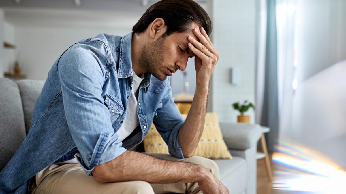 young-man-having-headache-holding-his-head-pain-home